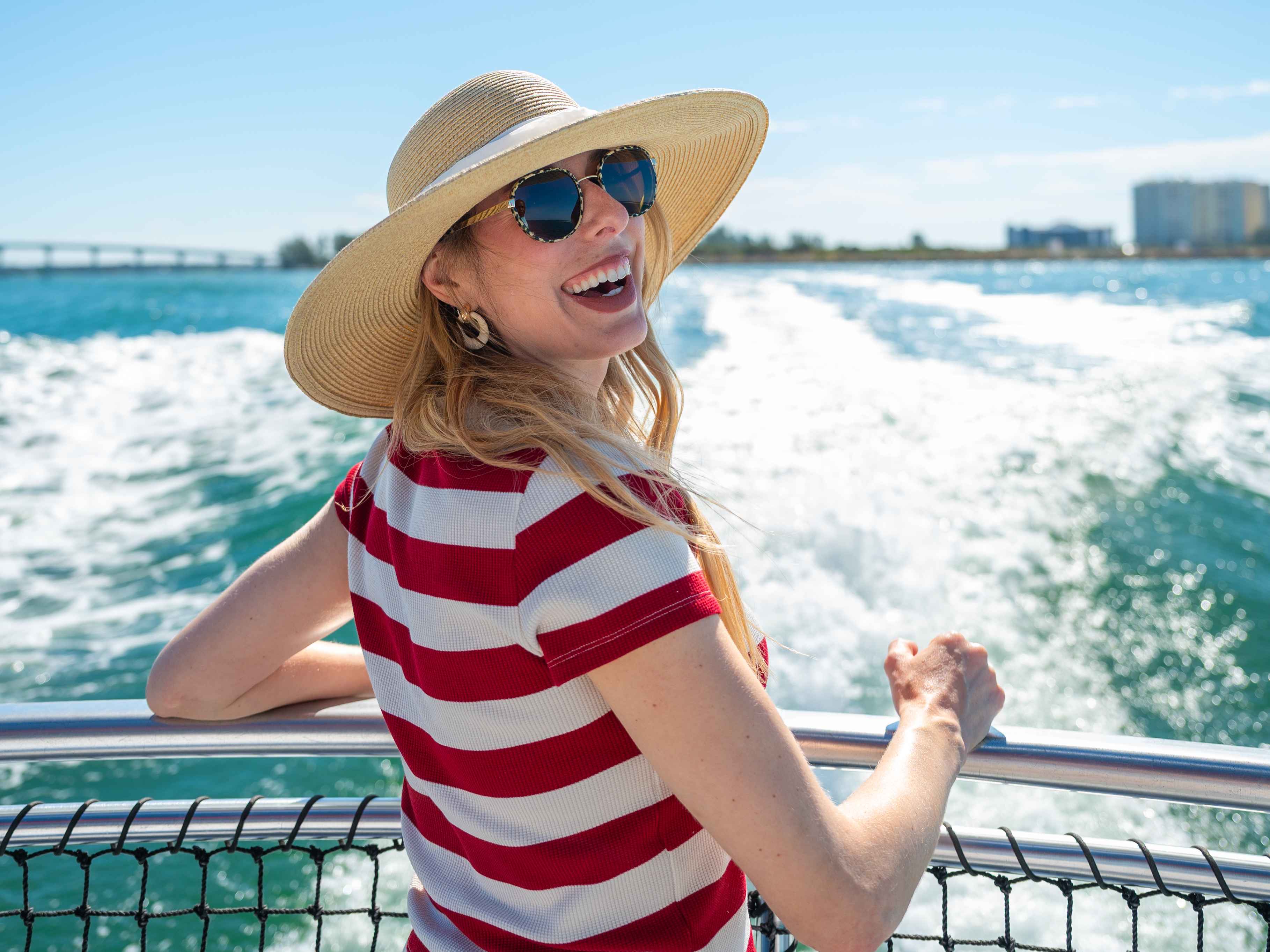 a smiling woman at the back of the Little Toot sightseeing boat