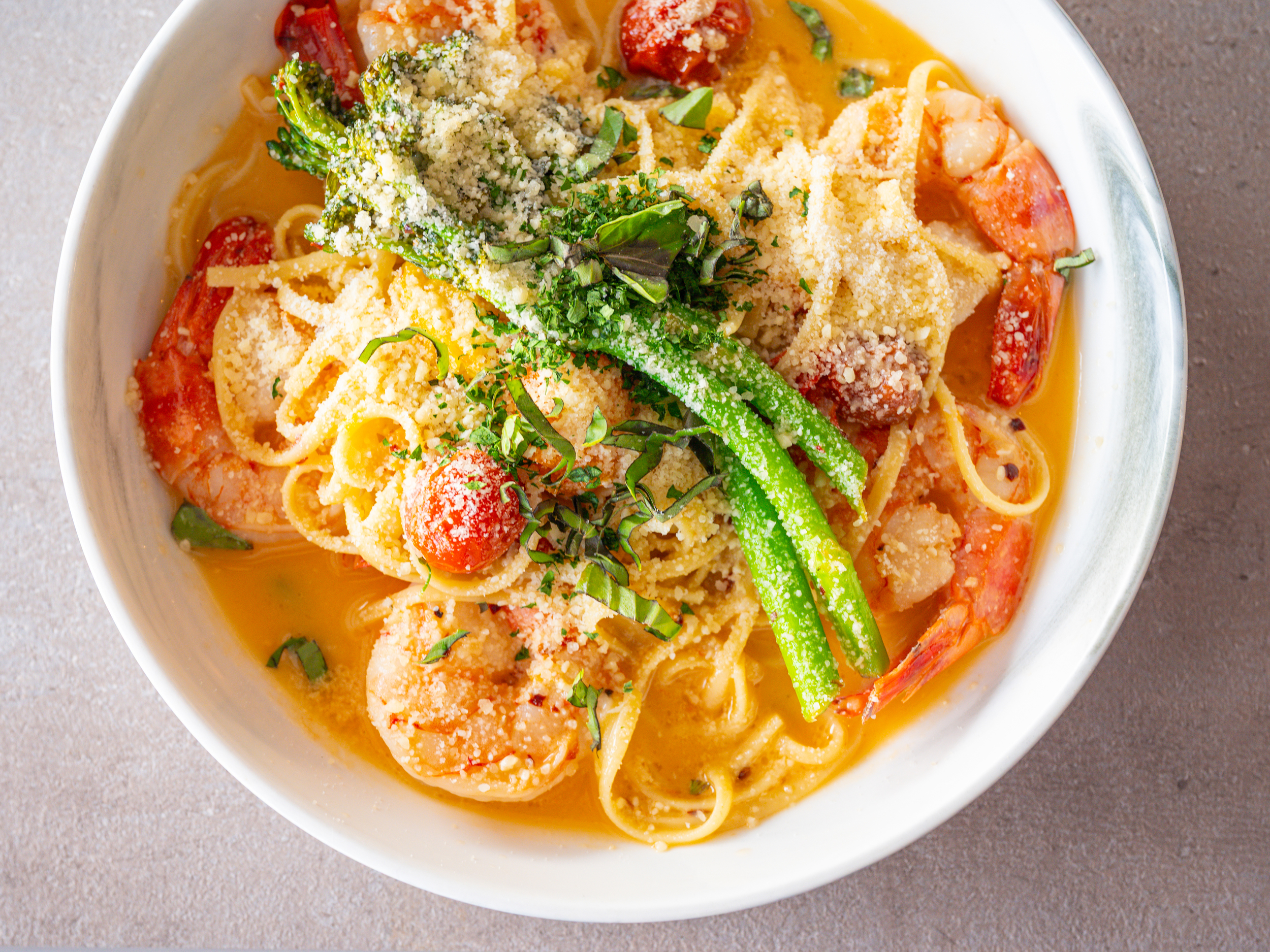 a plate of shrimp scampi with pasta and asparagus at Grace restaurant on St. Pete Beach