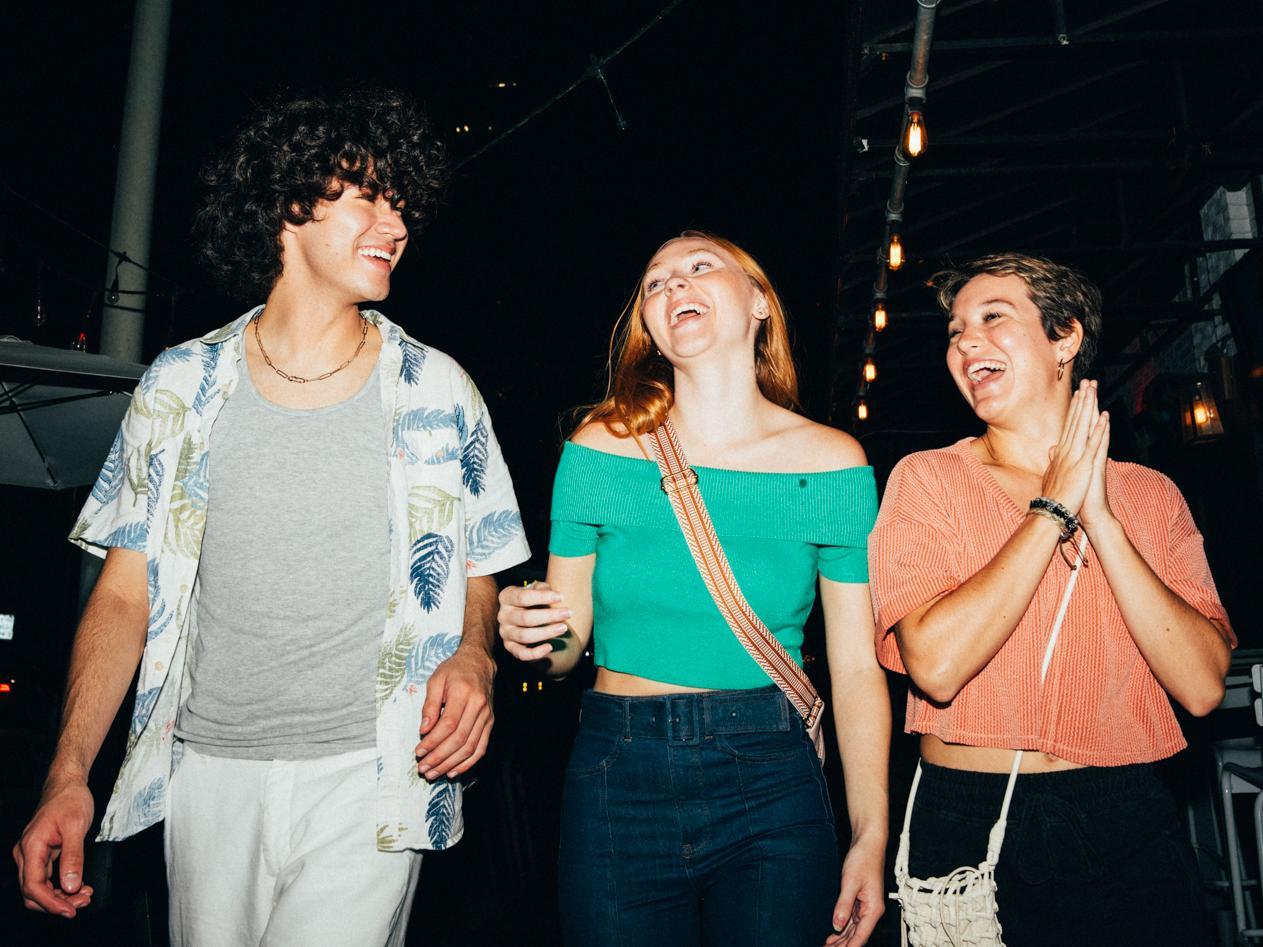 three friends laughing and talking at Park and Rec in St. Pete