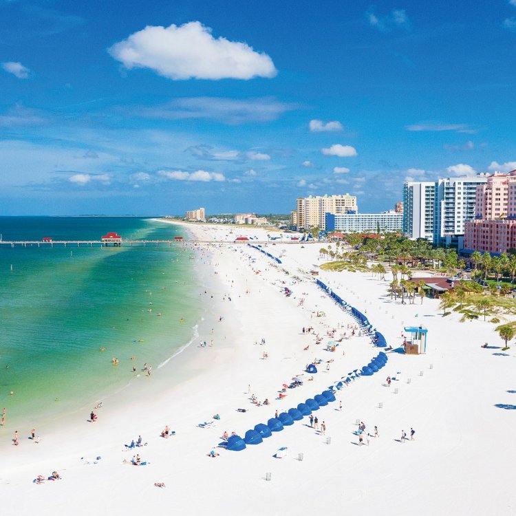 Aerial view of lively Clearwater Beach with white sands and emerald-green waters