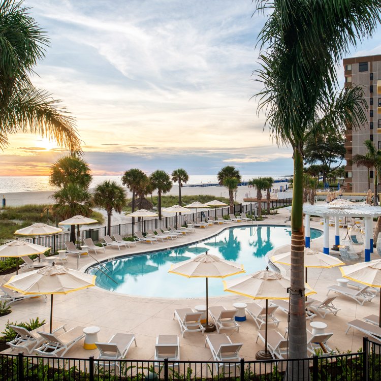 The pool at Sirata Resort with a view of St. Pete Beach horizon during sunset