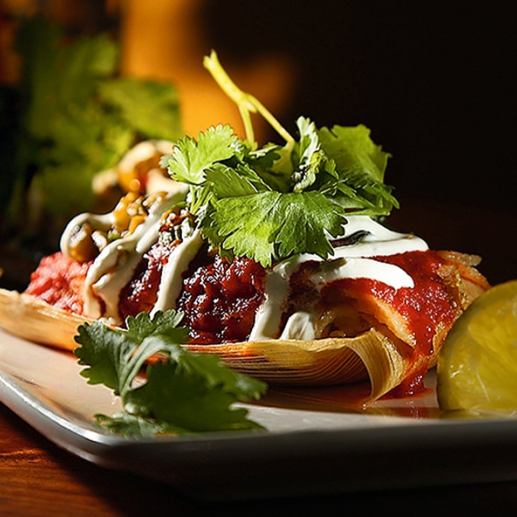 A salad topped with cilantro and lemon