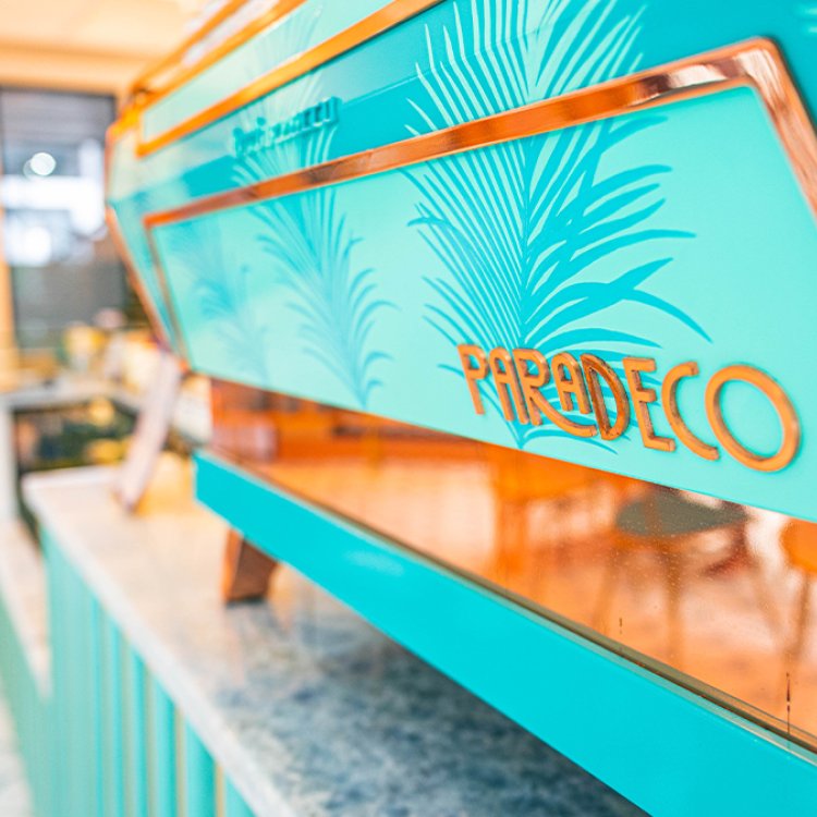 The interior view of the teal and gold sign of Paradeco Coffee.