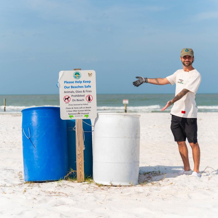 Caulin Donaldson, aka TrashCaulin, points to trash cans