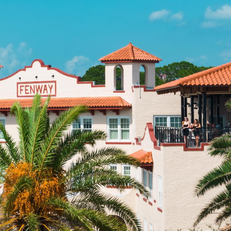 The Fenway Hotel with girls on balcony with palm trees, Dunedin Florida