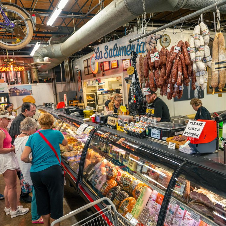 people stand in front of a deli counter at Mazzaro's Market in St. Pete