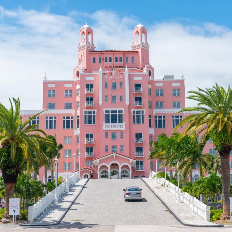 exterior of the historic don cesar hotel which looks like a bright pink castle with palm trees around it