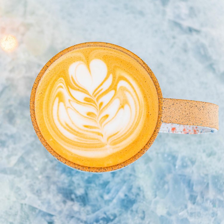 a view of a mug of hot latte with a delicate design