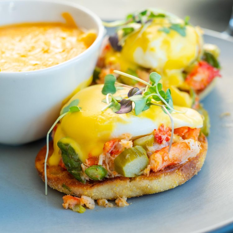 eggs benedict next to a cup of cheesy grits at Clear Sky Beachside Cafe in Clearwater Beach FL