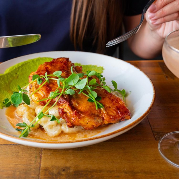 a person about to dig into a plate of food at Little Lamb Gastropub in Clearwater