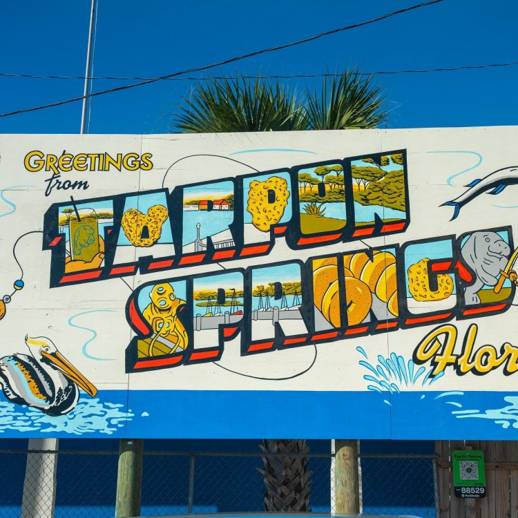 A colorful postcard-style mural reading "Greetings from Tarpon Springs, Florida"
