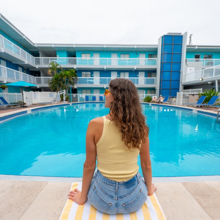 a woman sits poolside at the Bilmar Beach Resort