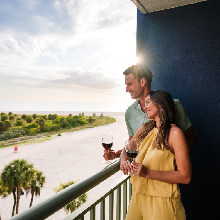 A couple looks out the balcony of Clearwater Beach Sheraton Resort