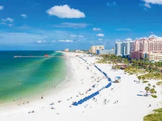 Aerial view of lively Clearwater Beach with white sands and emerald-green waters