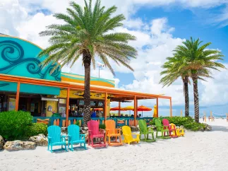 Colorful Adirondack chairs on the beach outside of Frenchy's Rockaway Grill