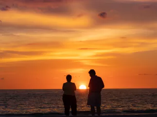 A couple watching the sunset in St. Pete Beach.