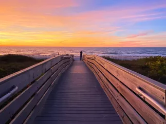 Man taking a photo of the beautiful sunset at Indian Rocks Beach.