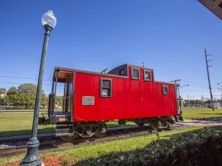 A red train caboose at Pinellas Park train station