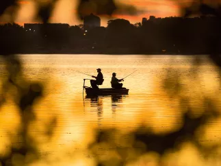 Silhouette of two men fishing at the Seminole Lake during sunset
