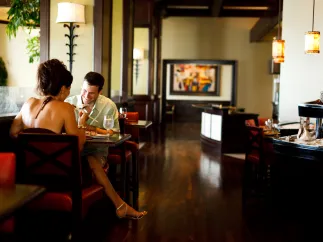 A couple enjoying a meal in an indoor setting of Caretta restaurant.