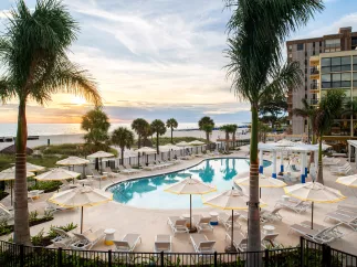 The pool at Sirata Resort with a view of St. Pete Beach horizon during sunset
