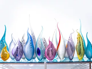 Colorful glass sculpture looking like fire flames at Imagine Museum
