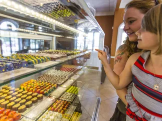 A mother and daughter looking at candies on display at William Dean candy store.
