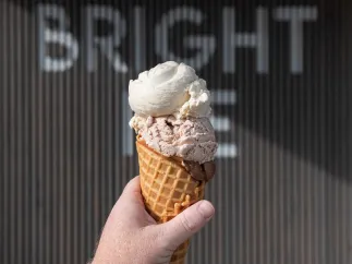 An ice cream cone in front of the Bright Ice Sign at their storefront in Pinellas Park