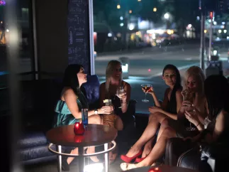 A group of woman talk over cocktails at a bar in downtown St. Pete