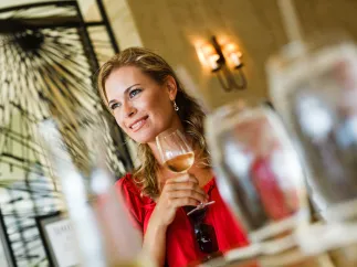 A woman holds up a wine glass at Caretta on the Gulf