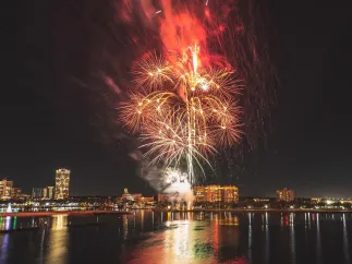 Red and white fireworks explode over the St. Pete skyline