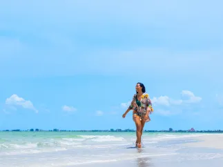 a lady walking on the beach
