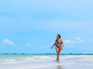 a lady walking on the beach