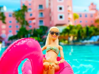 barbie in a bikini on top of a pink flamingo float in the pool at the Don CeSar hotel