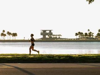 a runner near Tampa Bay with the St. Pete Pier in the background