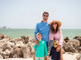 family standing on the beach