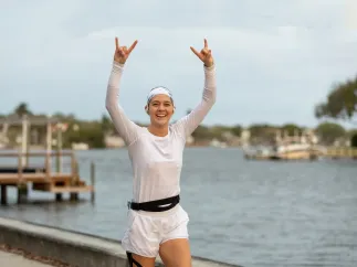 a young woman runs next to Coffee Pot Bayou during the St. Petersburg Distance Classic
