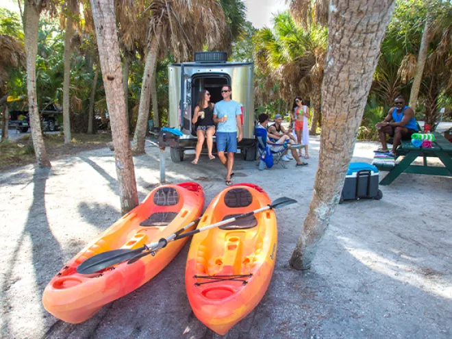 People camping at Fort de Soto park with kayaks in the foreground.