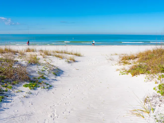 People walking in the white sands of Redington Shores