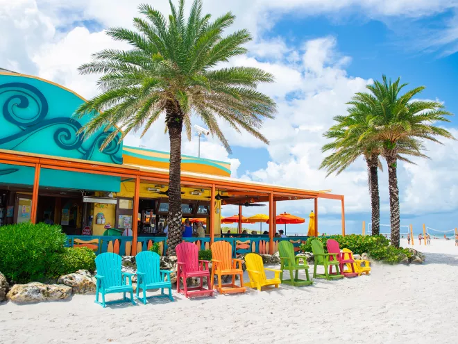 Colorful Adirondack chairs on the beach outside of Frenchy's Rockaway Grill