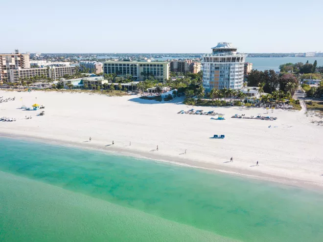 Aerial view of St. Pete Beach emerald-green waters with Bellwether Beach Resort in the background