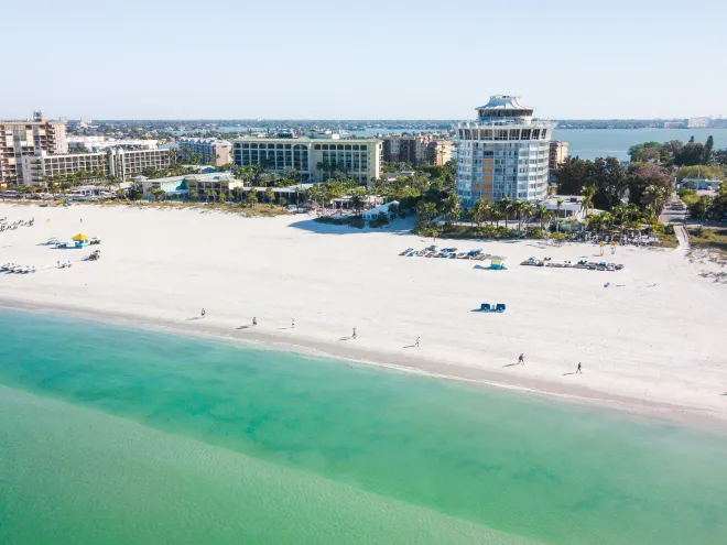 Aerial view of St. Pete Beach emerald-green waters with Bellwether Beach Resort in the background