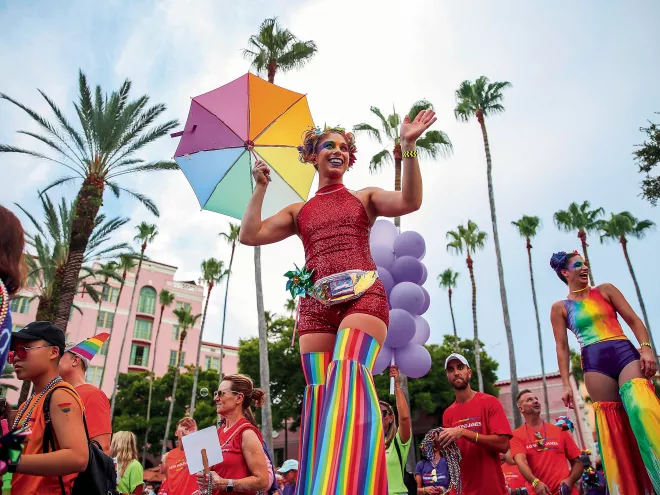 Marchers clad in rainbow clothing pass by the Vinoy during the St. Pete Pride Parade.