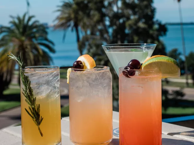 four cocktails on the railing of the Hi-Fi Cocktail at the Fenway Hotel