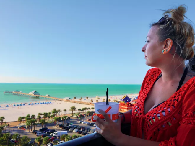 A woman looks out to the beach at Jimmy's Crow's Nest on Clearwater Beach