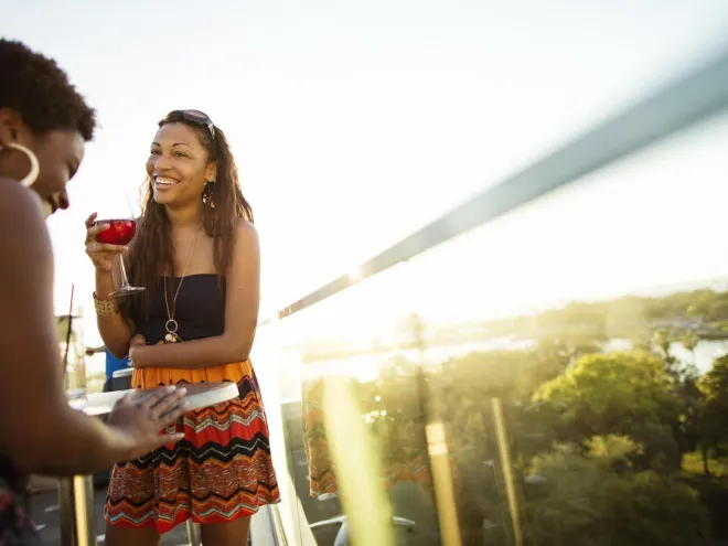 Two ladies enjoying cocktails at The Birchwood Canopy rooftop bar in downtown St. Pete