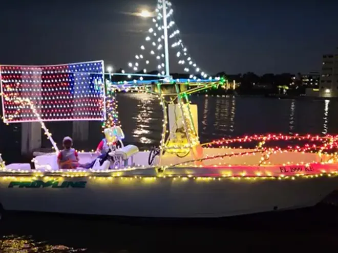 A powerboat lit up with holiday lights and decorations