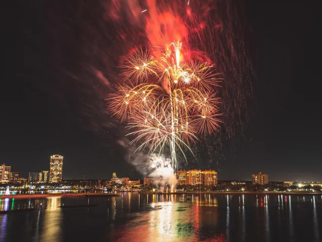 Red and white fireworks explode over the St. Pete skyline