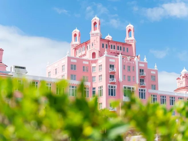 The Don CeSar Hotel with green bushes in the foreground
