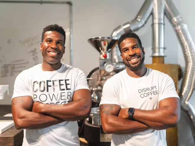 Twin black men wearing white T-shirts with coffee slogans